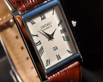 Reloj Seiko Slim Tank vintage con esfera blanca y caja dorada, pieza única.