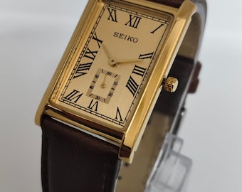 Reloj Seiko Slim Tank de cuarzo vintage – esfera dorada, tono dorado, reacondicionado, unisex.