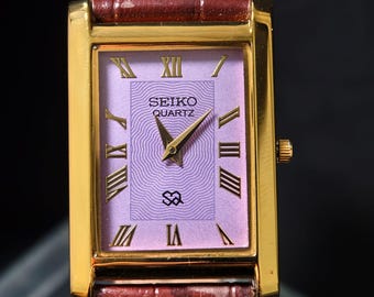 Reloj unisex Seiko Slim Tank vintage con esfera morada y tono dorado.