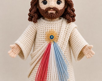 May include: A crocheted doll depicting a religious figure, wearing a gold crown and a cream-colored robe. The doll has brown hair and a beard, with a decorative emblem on the chest featuring red, white, and blue strands.