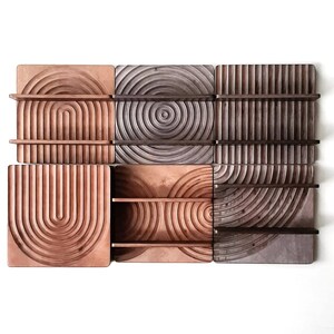 May include: A set of six wooden wall shelves with a geometric design. The shelves are made of different shades of brown wood and have a unique, modern look.