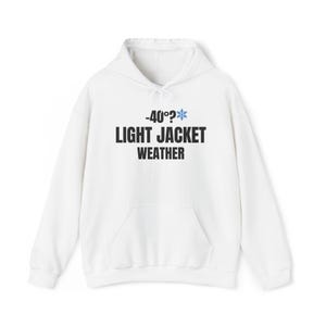 May include: White hooded sweatshirt with a front pocket. The text "-40°?" with a snowflake graphic and "LIGHT JACKET WEATHER" is printed in black. A casual, comfortable garment for cold weather.