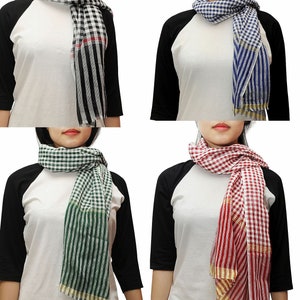 May include: Four scarves in various colours and patterns are shown. The scarves are draped around a person's neck. The patterns include checks and stripes in black and white, blue and white, green and white, and red and white. Each scarf has a gold trim.