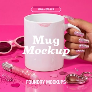May include: A white mug with a lipstick kiss mark, the words "Mug Mockup" in white, and a pink background. The image includes pink sunglasses, a lip gloss, heart-shaped confetti, and a heart-shaped keychain. The text "JPEG + PSD FILE" is also visible.