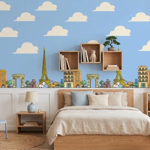 May include: A wall mural featuring a light blue background with white clouds and a repeating pattern of Parisian landmarks including the Eiffel Tower and the Arc de Triomphe, interspersed with yellow buildings, green trees, and small animal figures.
