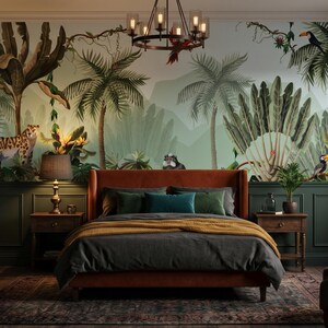 May include: A bedroom featuring a large wall mural depicting a tropical jungle scene with palm trees, a leopard, and toucans. The room includes an orange upholstered bed frame, dark green paneled walls, two wooden nightstands, and a brown armchair.