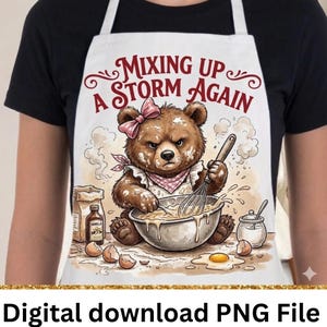 May include: White apron with a cartoon bear wearing a pink bow and bandana, whisking batter in a bowl. Text reads "Mixing Up A Storm Again." Includes eggs, vanilla, and sugar.