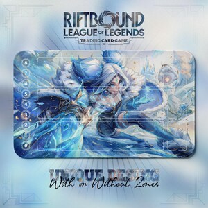May include: A rectangular Riftbound League of Legends trading card game playmat. The mat features a detailed illustration of a female character in shades of blue and white. The top of the mat has the game's logo and the text "Trading Card Game". The bottom of the mat has the text "Unique Design With or Without Zones".
