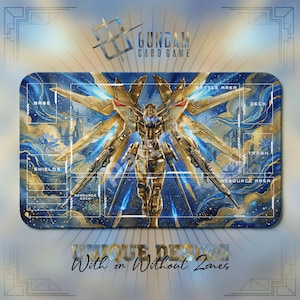 May include: A rectangular Gundam card game playmat featuring a golden robot with large wings against a blue and gold watercolor background. The mat has labeled zones for gameplay, with the text "UNIQUE DESIGN With or Without Zones".