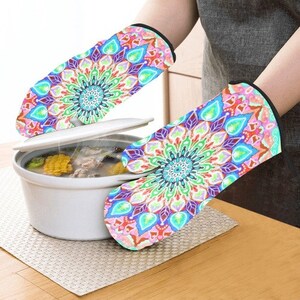 May include: A pair of colorful oven mitts with a mandala design. The mitts are made of heat-resistant fabric and are perfect for protecting your hands while cooking or baking.