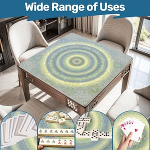 May include: A square wooden table with a mandala pattern on the surface. The table is surrounded by chairs. The image includes the text "Wide Range of Uses" at the top. Various games are displayed on the table, including cards, dominoes, and mahjong.