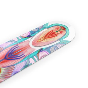 May include: A colorful bookmark with a pink, blue, and yellow design. The bookmark has a cut-out shape in the center, allowing it to be used to mark a page in a book.
