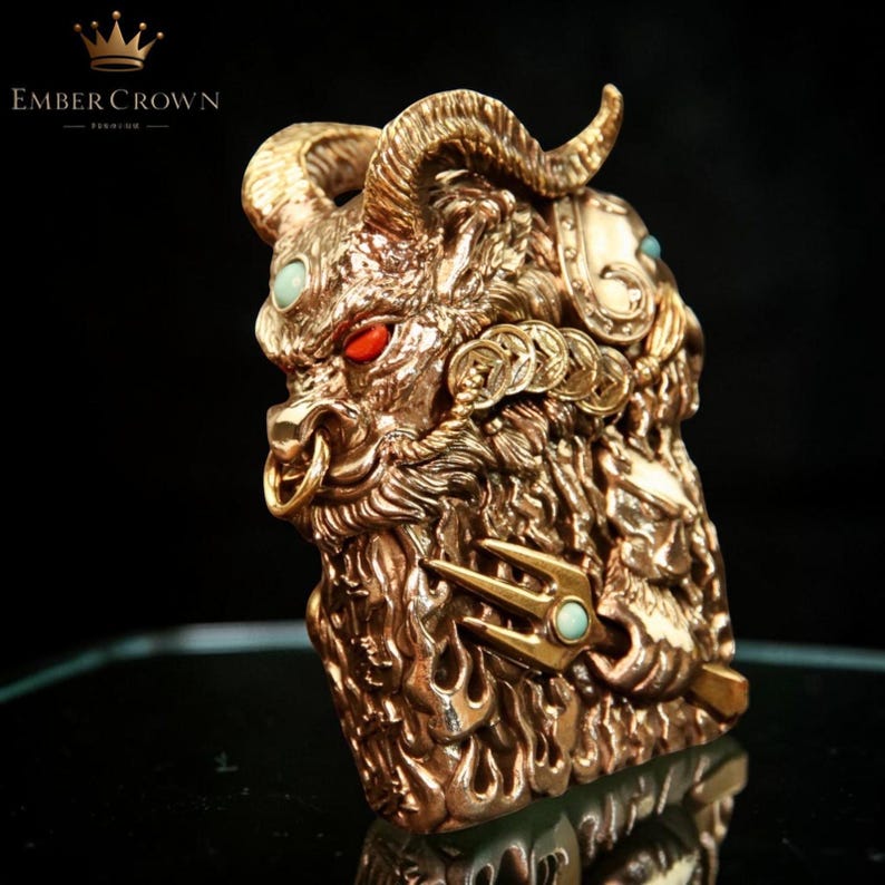 K&ouml;nnte beinhalten: Eine detaillierte, goldfarbene Skulptur einer bullenartigen Kreatur mit roten Augen und t&uuml;rkisfarbenen Akzenten. Die Skulptur weist komplizierte Details wie H&ouml;rner, M&uuml;nzen und einen Dreizack auf. Das Ember Crown-Logo ist sichtbar.