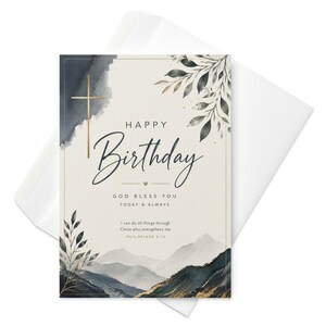 May include: A rectangular birthday greeting card with a cream background, featuring a gold cross, dark blue watercolor mountain landscape, and leafy branches. Text reads: Happy Birthday, God bless you today & always, I can do all things through Christ who strengthens me. Philippians 4:13.