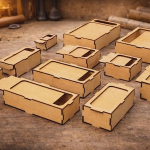 May include: A collection of various sized, unfinished wooden boxes with rectangular and square shapes. Some boxes have lids, and others have open tops. The boxes are arranged on a textured, brown surface, suggesting a craft or woodworking theme.
