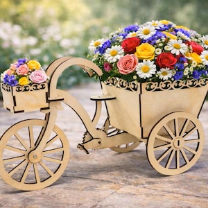 May include: A wooden bicycle-shaped flower planter with two baskets filled with colorful flowers. The flowers include red, yellow, pink, white, and blue blooms. The planter is made of light-colored wood and has decorative cutouts.