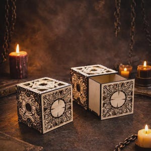 May include: Three wooden puzzle boxes with intricate geometric designs, one open, sit on a dark surface. The boxes are surrounded by candles and chains, creating a mysterious atmosphere. The boxes are approximately 4 inches in size.
