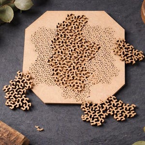 May include: A wooden puzzle with a complex, geometric design. The puzzle is partially assembled, with several pieces scattered around a central, octagonal base. Additional pieces are in a small wooden bowl.