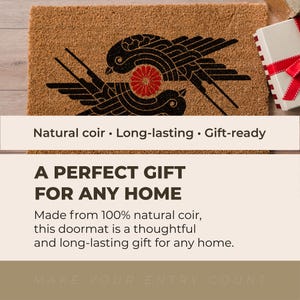 May include: A rectangular natural coir doormat featuring a black graphic print of two stylized birds facing each other with a red circular floral emblem positioned between them. The mat has a coarse, fibrous texture and a light brown tan color.