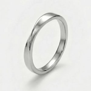 May include: A silver-colored ring with a twisted design. The ring has a smooth, polished surface and a simple, elegant style. The ring is likely made of a precious metal.