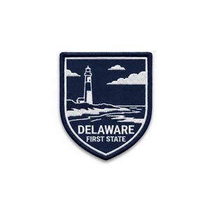 May include: A navy blue patch featuring a white lighthouse, waves, and clouds. The shield-shaped patch has the text "DELAWARE FIRST STATE" in white.