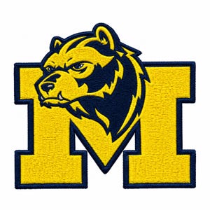 May include: An embroidered patch featuring a stylized yellow and navy blue wolverine head mascot positioned over a large, block-style letter M. The design uses bold yellow thread for the wolverine and letter, outlined in dark navy blue thread.