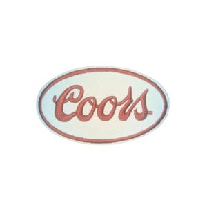 May include: Oval-shaped patch with the word "Coors" in red script lettering. The patch has a white background with a red border. The design is simple and classic, suitable for apparel or accessories.