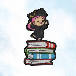 May include: Embroidered patch featuring a cartoon graduate with pink hair, wearing a black cap and gown, standing atop a stack of books. The books have red, green, and blue covers. The graduate is winking and giving a peace sign.