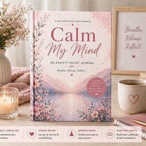 May include: A journal titled "Calm My Mind" with floral and landscape illustrations. The cover text reads "An Anxiety Relief Journal" and "Breathe. Release. Reflect." A framed print with the words "Breathe. Release. Reflect." is visible.