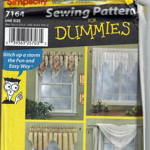 May include: A Simplicity 7164 sewing pattern envelope for window treatments, titled Sewing Pattern FOR DUMMIES. The yellow and black packaging displays four different curtain styles labeled A, B, C, and D, featuring floral and solid white fabrics.