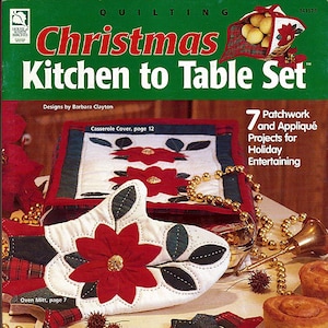 May include: A Christmas-themed quilting pattern book with a red and white oven mitt, a red and white casserole dish cover, and a red and white trivet. The book includes 7 patchwork and appliqué projects for holiday entertaining.