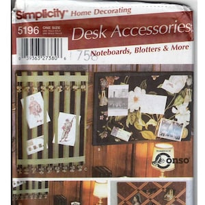 May include: A Simplicity sewing pattern for desk accessories, including noteboards, blotters, and more. The pattern shows three different designs for desk organizers, each with a different style and color scheme. The pattern number is 5196.