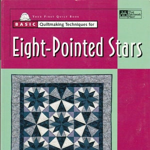 May include: A book titled "Your First Quilt Book" with "Basic Quiltmaking Techniques for Eight-Pointed Stars" on the cover. The cover features a quilt design with blue, white, and gray eight-pointed stars. The author's name, Sherry Reis, is at the bottom.