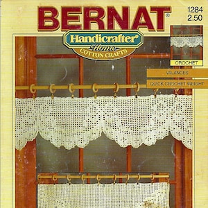 May include: A vintage Bernat Handicrafter Home Cotton Crafts pattern for crocheted valances. The image shows two cream-colored, scalloped valances hanging on a wooden rod. The top of the image features the Bernat logo and the words "Handicrafter Home Cotton Crafts".