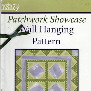 May include: Patchwork Showcase Wall Hanging Pattern sewing with nancy. The pattern features a quilt design with a green and purple color scheme.