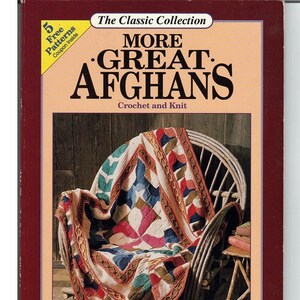 May include: Book cover for "More Great Afghans" crochet and knit patterns. The cover features a colorful afghan draped over a wooden chair. The book is part of "The Classic Collection" and includes 5 free patterns.