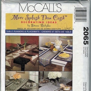 May include: McCall's sewing pattern for table runners and placemats. The cover features four images of decorated tables with various runner and placemat designs. The text reads "More Splash Than Cash" and "Decorating Ideas by Donna Babylon."