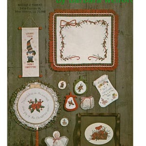 May include: A collection of Christmas-themed needlepoint crafts, including a banner, a framed piece, a table mat, and various ornaments. The crafts feature festive designs with red, green, and white colors, perfect for holiday decor.