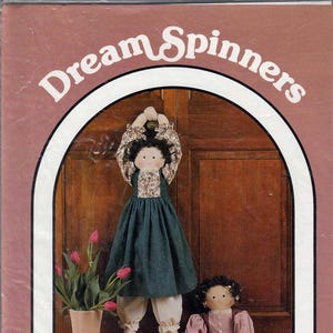 May include: A craft pattern cover featuring two fabric dolls, one hanging and one seated. The hanging doll is approximately 28 inches tall. The dolls are dressed in vintage-style clothing. The text "Dream Spinners" is at the top.