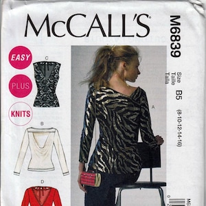 May include: McCall's sewing pattern M6839. The pattern includes options for tops with various necklines and sleeve lengths. The main image shows a woman wearing a long-sleeved top with a black and gold zebra print. The pattern is marked as "Easy" and "Plus" sizes.