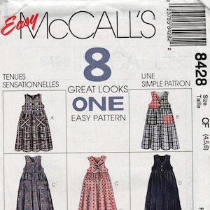 May include: A vintage McCall's sewing pattern featuring eight dress designs. The pattern includes various styles, from plaid to solid colors, with sizes for children. The pattern number is 8428, and the cover has the text "Easy McCall's".