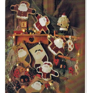 May include: A set of eight holiday-themed fiber mosaic patterns featuring Santa Claus in various poses. The patterns are printed on a green background with the text "88701 HOLIDAY FRU-FRU FIBER MOSAICS" and contact information for the company.
