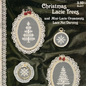 May include: A book cover with the title "Christmas Lacie Trees and Mini-Lacie Ornaments Lace Net Darning" by Hazel Hodgson. The cover features four white lace ornaments with a Christmas tree design.