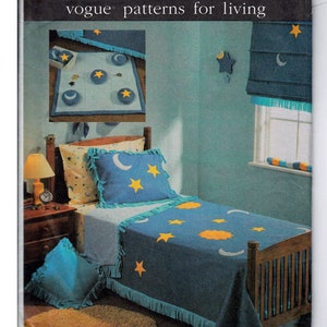 May include: A blue and yellow star and moon patterned bedspread with a fringe border. The bedspread is on a twin-sized bed with a wooden headboard. There is a blue throw pillow on the bed and a brown shag rug on the floor. The image is from a vintage sewing pattern for a bedspread.