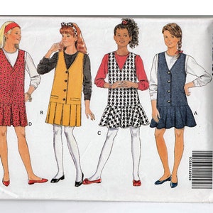 May include: A sewing pattern for a sleeveless dress with a button-up front. The pattern is for sizes 6-14 and is from Butterick pattern number 6369. The pattern is labeled "Fast & Easy".