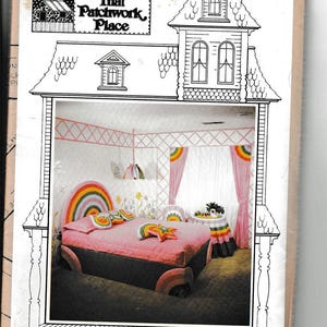 May include: A vintage magazine cover titled "Calico Decor" from "That Patchwork Place." The image showcases a whimsical bedroom design with a rainbow-themed bed, curtains, and decorative elements. The design is labeled "Rainbow Repeat."