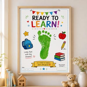 May include: A framed poster with the text READY TO LEARN! featuring a large green footprint in the centre. Illustrations include a blue backpack, a red apple, a yellow pencil, and a stack of books. Text reads Little feet with big dreams!