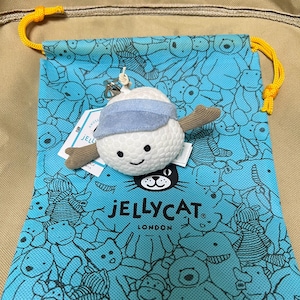 May include: A white ceramic mug with a black handle and the text "But First, Coffee" in a black, handwritten-style font. The mug is on a white surface.