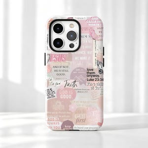 May include: A smartphone case featuring a collage of pink and white religious-themed text, inspirational quotes, and illustrations including a butterfly, praying hands, and flowers. The design includes phrases like God is Good, Faith, and Love them anyway.