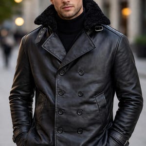May include: A black leather jacket with a shearling collar. The double-breasted coat has large black buttons and a notched lapel. The model is wearing a black turtleneck. The jacket has pockets and a belt detail on the sleeves.